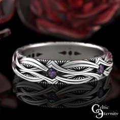 an artisticly designed wedding band with amethorate and purple stones in the center