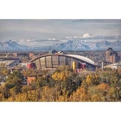 the mountains are in the distance behind this stadium