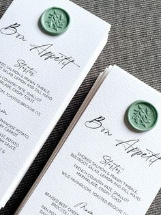 two wedding programs with wax stamp on them