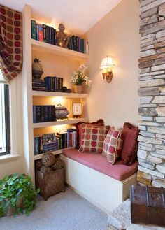 a living room filled with lots of furniture and bookshelves next to a window