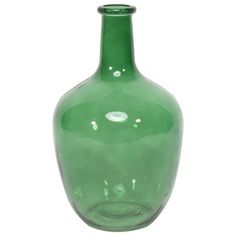 a green glass vase sitting on top of a white table