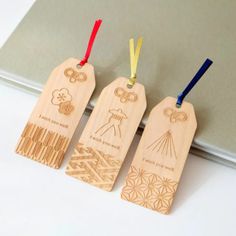 three wooden tags with different designs on them