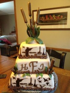 a three tiered cake sitting on top of a wooden table