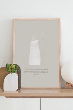 a white vase sitting on top of a wooden shelf next to a potted plant