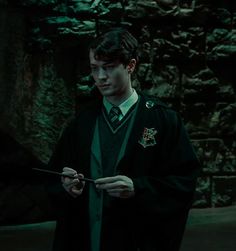 a man in a harry potter costume holding a wand