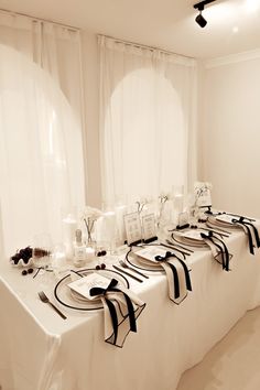 the table is set up with black and white decorations