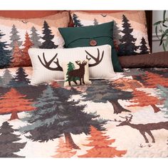 a bed with a deer and pine trees on it