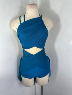 a female mannequin wearing a blue top and shorts