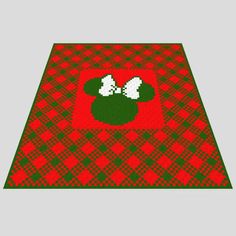 a red and green plaid area rug with mickey mouse ears on it's side