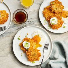 two white plates topped with fried eggs and hash browns next to a cup of tea