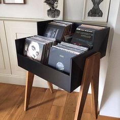 a wooden stand with several records in it