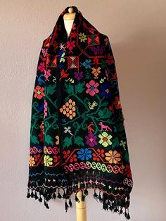 Collectors vintage Mexican wool shawl from Puebla region - very colorful patterns and fringed 30 1/2" wide x 88" length. Warm and festive - vintage in excellent condition. Could also made into a poncho if you can bind off the neck-hole or V seams. Perfect for your textile collection - to wear or drape on bottom of a bed or couch.  FREE FAST shipping yours in 4 - 5 days. Folk Style Black Shawl For Winter, Black Embroidered Bohemian Shawl, Multicolor Traditional Shawl With Tassels, Traditional Multicolor Shawl With Tassels, Traditional Multicolor Tasseled Shawl, Bohemian Black Shawl With Woven Motifs, Black Bohemian Shawl With Woven Motifs, Black Folk Style Shawl For Festival, Black Shawl Scarf With Traditional Patterns