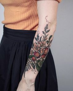 a woman with a flower tattoo on her arm