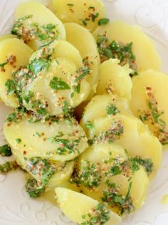 a white plate topped with potatoes covered in seasoning