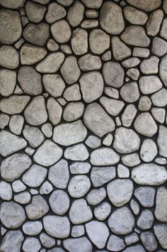 the stone wall is made up of small rocks