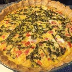 there is a pie with many toppings in the pie pan on the counter top