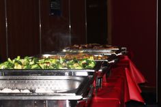 a buffet line with many different types of food on it's serving trays