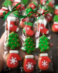 christmas cookies are in plastic bags with green and red decorations on them, as if they were decorated for the holiday season