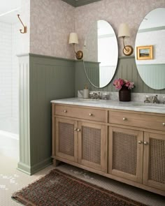 a bathroom with two sinks and mirrors on the wall