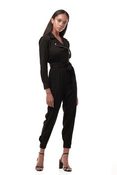 The moto details are immaculate on our new Moto Jumpsuit, crafted from easy lightweight drape fabric with an asymmetrical zip at front, elegant collar, and built in belting detail. — Moto-inspired neckline— Side seam pockets — Ribbed hem— 100% rayon SIZE + FIT— Tie waist— Form fitting— Fits true to size— The model is 5'9 and wearing a size XS CARE— Dry clean only Sleek Workwear Jumpsuits And Rompers For Fall, Sleek Jumpsuits And Rompers For Fall Workwear, Sleek Fall Workwear Jumpsuits And Rompers, Sleek Black Jumpsuits And Rompers For Work, Black Belted Jumpsuits And Rompers For Fall, One Piece Outfit Jumpsuit, Drape Fabric, One Piece Outfit, Design Competitions