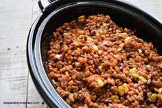 a crock pot filled with beans and other things to make it look tasty