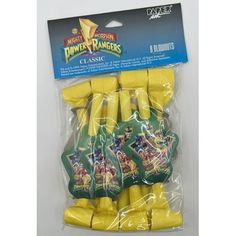 the package contains several pieces of yellow plastic fruit, including bananas and pineapples