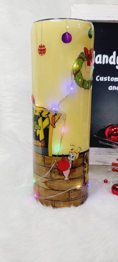 a glass vase sitting on top of a white table next to a christmas ornament