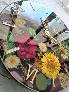 a clock with flowers painted on the face