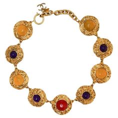 Condition : very good Made in France Materials : gold plated metal, resin Colors : yellow, amethyst, ruby Measurements : length: 39 cm + 5 cm of adjustable chain, size of a coin medallion : 3 x 3 cm Gold finish metal Stamp : yes Year : 1990-1992 Details : A succession of inlaid pieces in gilded metal with a resin stone at the center of each one. Snap hook closure. Flexibility of 8 cm to adjust the chain length. A CC charm at the end of the chain. No visible sign of wear. Comes in its original bo Resin Colors, Ivory Necklace, 1980s Jewelry, Vintage Chanel Bag, Vintage Choker Necklace, Resin Stone, Chocker Necklace, Vintage Choker, Horn Necklace