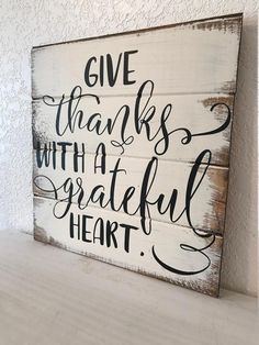 a wooden sign that says give thanks with a grateful heart