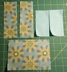 four pieces of fabric sitting on top of a cutting board