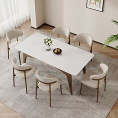 a white table with six chairs and a bowl of fruit on the dining room table