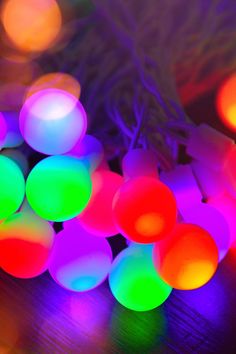 multicolored lights sitting on top of a wooden table