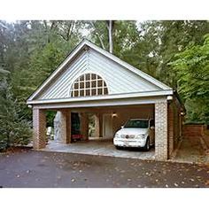 a white car parked in front of a garage