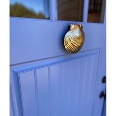 a blue door with a gold shell on it