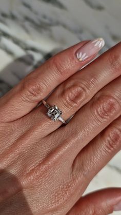 a woman's hand with a ring on it