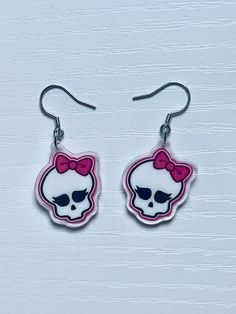 ☆ Girly skull acrylic earrings! ☆ Earrings inspired by a certain monster high school logo! The skulls are handdrawn by me, in my own style!  Details: - Acrylic size: 1" - Double-sided - Hand drawn artwork  - Silver ear hooks Thank you so much for your support! ~ **Disclaimer: These earrings do NOT come with a doll, the doll in the image is used for advertising purposes only Girly Skull, Monster High School, School Logo, Ear Hook, Acrylic Earrings, Monster High, Halloween Shopping, Jewelry Earrings Dangle, Etsy Earrings