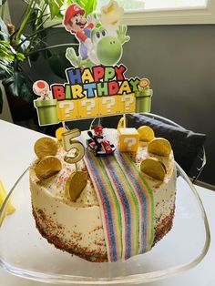 a birthday cake sitting on top of a glass plate