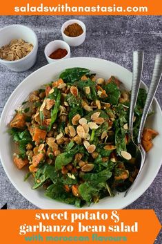 a salad with spinach, sweet potato and garbanzo bean salad in it