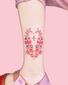 a woman's foot with a tattoo on it