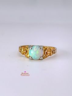 Item Description: This exquisite opal ring is a true gem from the Antique Edwardian/Art Deco period. Crafted in 14K yellow gold with intricate carved detailing on the band, this ring showcases a stunning pale blue opal with captivating red undertones when exposed to light. The single stone opal is cut in a cabochon style, measuring approximately 7mm in width, 7mm in length, and 4mm in depth. The band width is a delicate 1mm at its shortest. Don't miss the opportunity to own a piece of history with this timeless and elegant opal ring. Key Information: - Category: Fine Jewelry - Era: Antique Edwardian/Art Deco Period - Metal: 14K Yellow Gold with White Gold Prongs - Stone: Opal - Stone Shape: Cabochon - Stone Color: Pale Blue with Red Undertones - Size: Approximately 6.5 - Measurements: 7mm Gold Opal Ring With Birthstone, Gold Opal Birthstone Ring, Yellow Gold Cabochon Opal Ring, Heirloom Gold Opal Ring With Cabochon, Heirloom Gold Opal Cabochon Ring, Antique Gold Opal Ring Collectible, Antique 14k Gold Hallmarked Opal Ring, Collectible Gold Opal Ring With Gemstone, Yellow Gold Cabochon Opal Ring Collectible