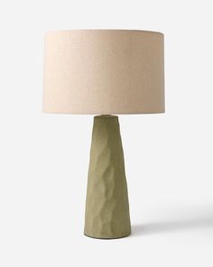 a table lamp with a beige shade on it's base and a white linen lampshade