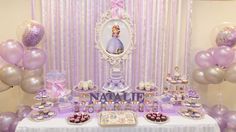 a table topped with lots of cakes and cupcakes