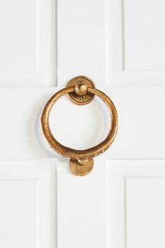 an old brass door handle on a white door