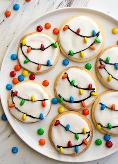 cookies decorated with icing and colored candies on a plate