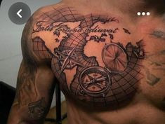 a man's chest with a map and compass tattoo on it