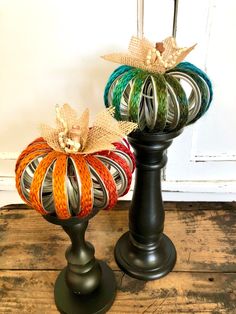 two decorative pumpkins sitting on top of pedestals