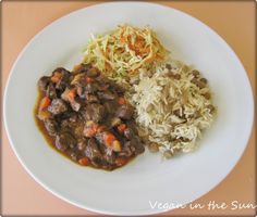 a white plate topped with rice and meat