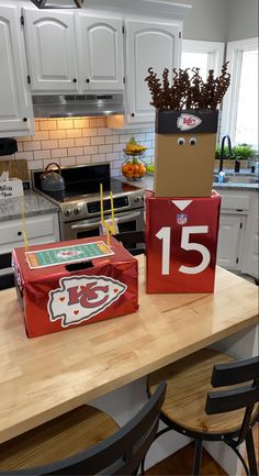 two cardboard boxes sitting on top of a kitchen counter