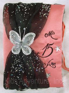 a pink and black bag with a butterfly on it's back, decorated with sequins